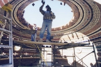 Two people work on constructing a stone dome. U.K. Architect to Address Tangible Spirituality and Sustainable Architecture