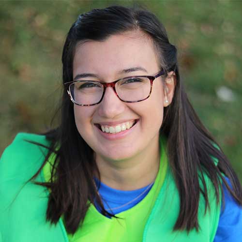 A dark haired woman with glasses.