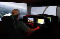 An aviation student practicing on Marywood's flight simulator.