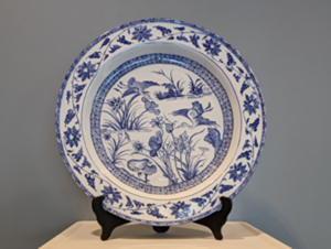 Round platter dish embellished with blue cranes and floral patterns