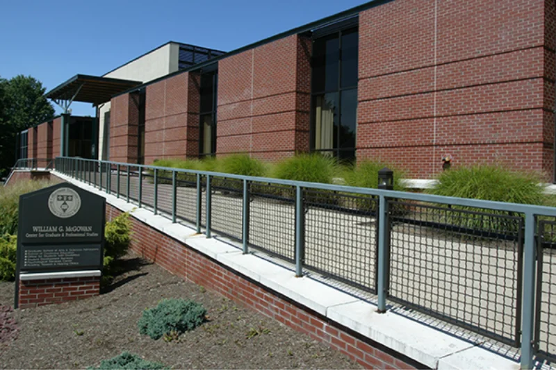 The front of the McGowan Center with a metal fence serving as a railing over an edge