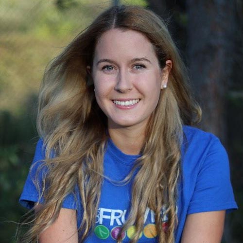 A blonde woman in a blue T-shirt.