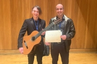 Two men are pictured, one holding a guiar and one holding a certificate. Marywood Student Kyle Jenkins Wins Competition at Prestigious International Guitar Festival
