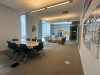 open area with a conference table and chairs and marywood decals on walls