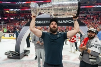 Man with a beard holding the silver Stanley Cup in an ice rink. The Stanley Cup Will Be at Marywood on Labor Day!