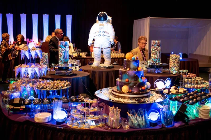 An astronaut figurine is surrounded by galaxy-themed desserts with special lighting to complete the atmosphere of the winning theme. Marywood University Captures Gold Award in National Dining Contest