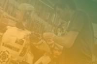 ombre green and gold filter over a man working on an animatronic robot Marywood Adds New AI Minors