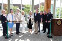 Marywood officials gather to cut a ceremonial ribbon signifying the dedication and opening of the new Pascucci Family Health Sciences Pavilion at Marywood. People are gathered and cutting a large ribbon in the atrium of the building. Pascucci Family Health Sciences Pavilion Dedicated