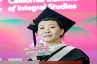 A woman speaking from a podium during the Zijing Education Graduation Ceremony in Beijing, China. Zijing-Marywood Honors the First Cohort of MBA and EMBA Graduates