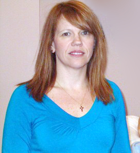 A woman with red hair in a blue shirt.