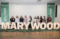 Students gather around lighted letters that spell out MARYWOOD. New Endowed/Annual Scholarships and Programmatic Endowment Announced