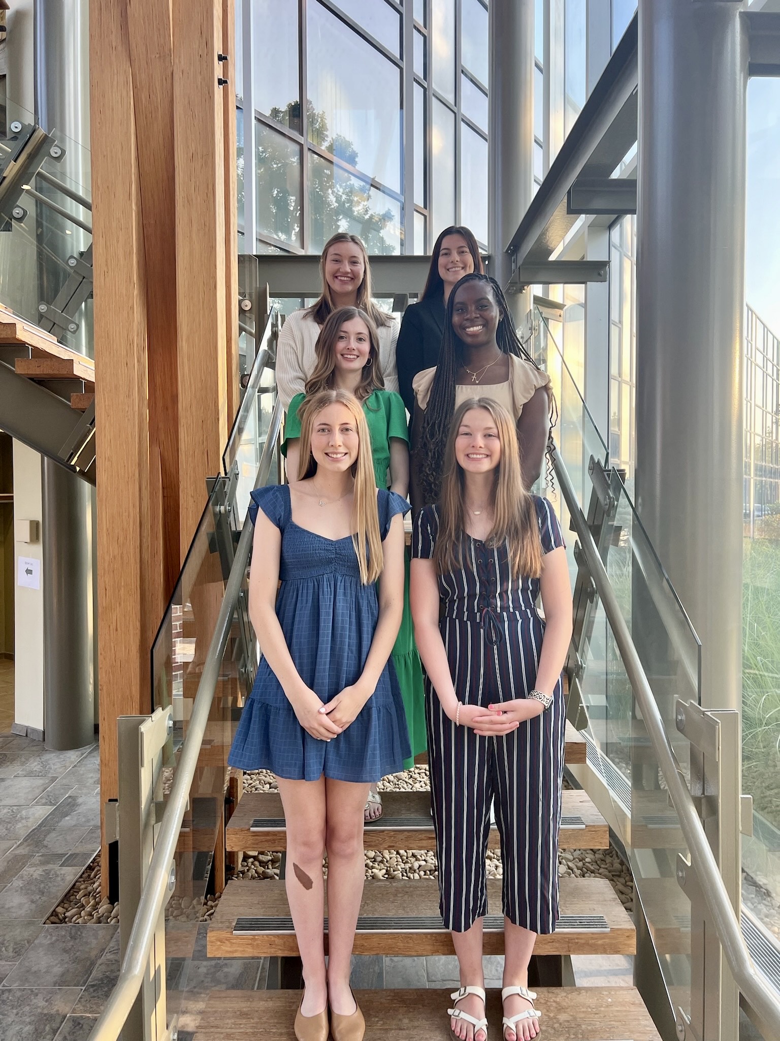 students standing on steps in building