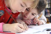two children close up drawing Early Childhood Education Program Ranks Among Best in the Nation